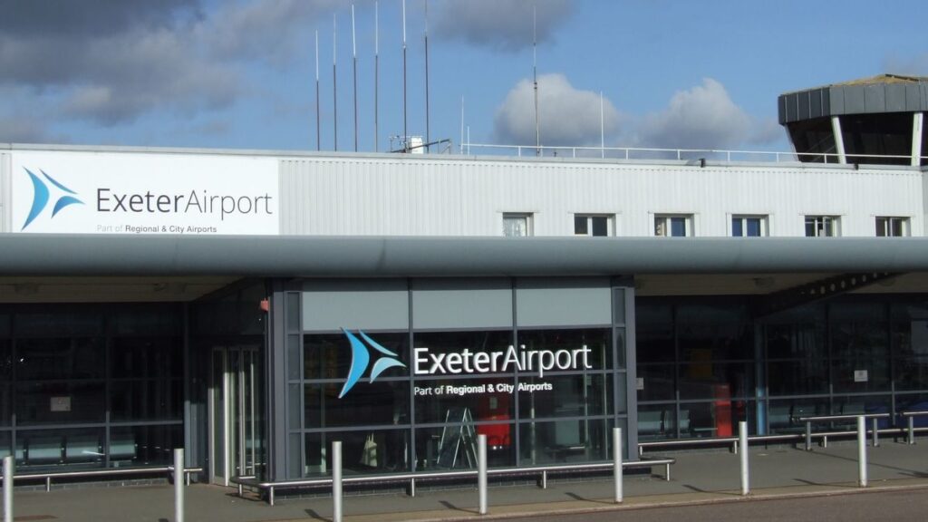 The entrance of Exeter airport with logo and sliding doors