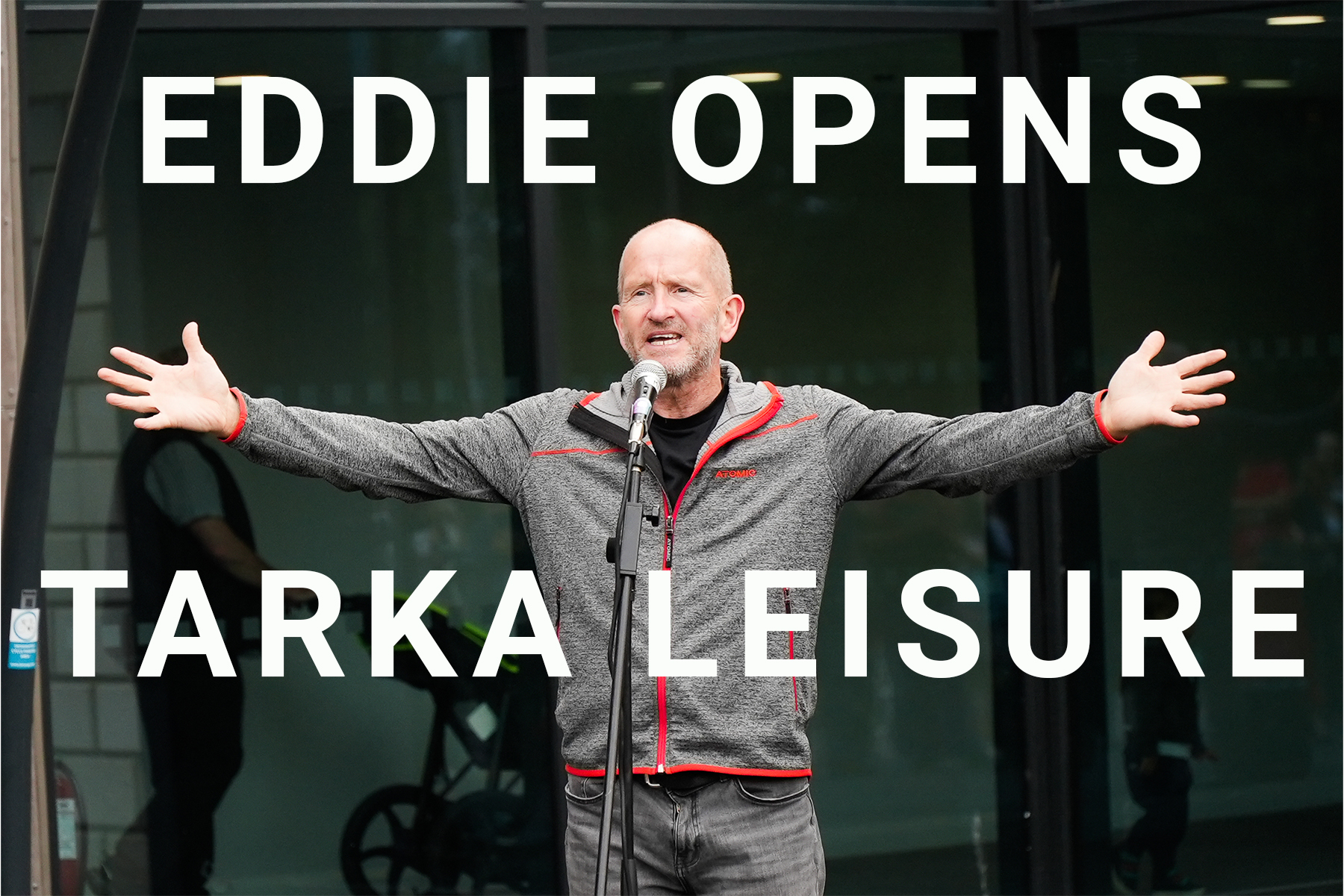Eddie the Eagle Edwards standing arms aloft at the opening of Tarka Leisure Centre