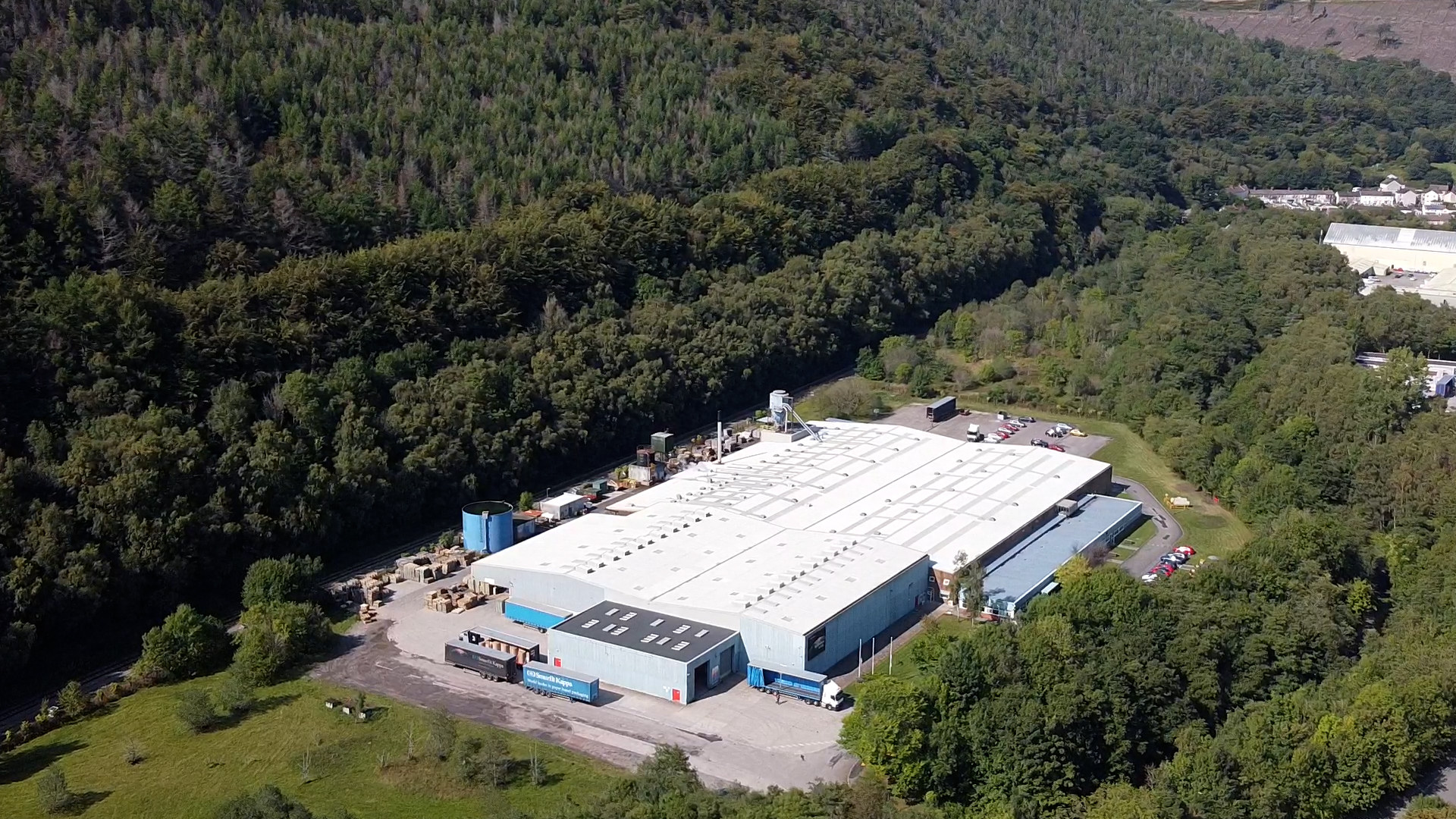 SW Abercan An industrial building located within a wooded area
